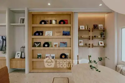 Stylish modern living room with wooden shelves and vinyl records, perfect for music lovers.
