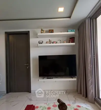 Modern living room with wall-mounted TV and decorative shelves