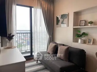 Modern living room with balcony view, stylish decor, and natural light.