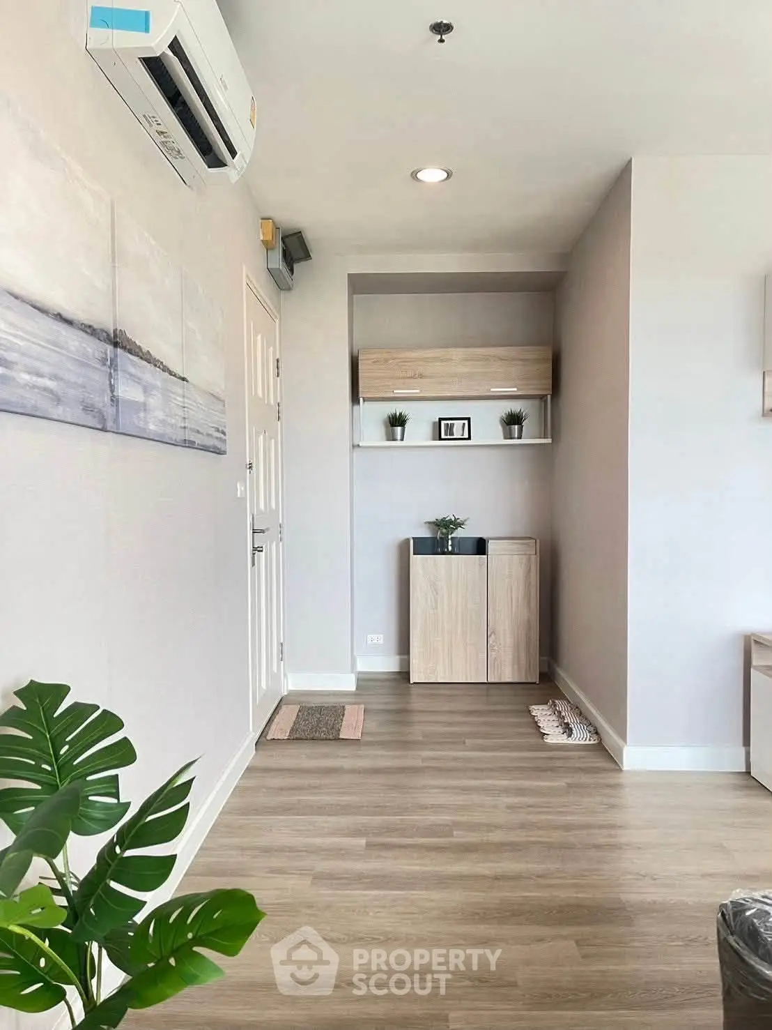 Modern living room with wooden flooring and stylish decor in a bright apartment.