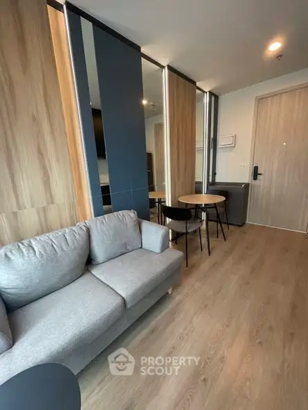 Modern living room with stylish decor and cozy seating in a contemporary apartment.