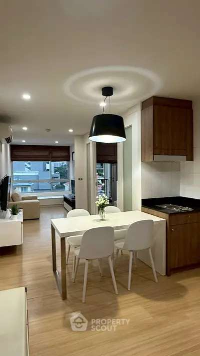 Modern open-plan living and dining area with stylish decor and natural light.