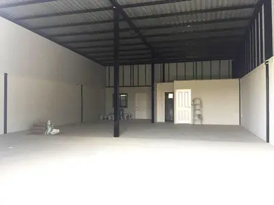 Spacious industrial warehouse with high ceilings and ample storage space.