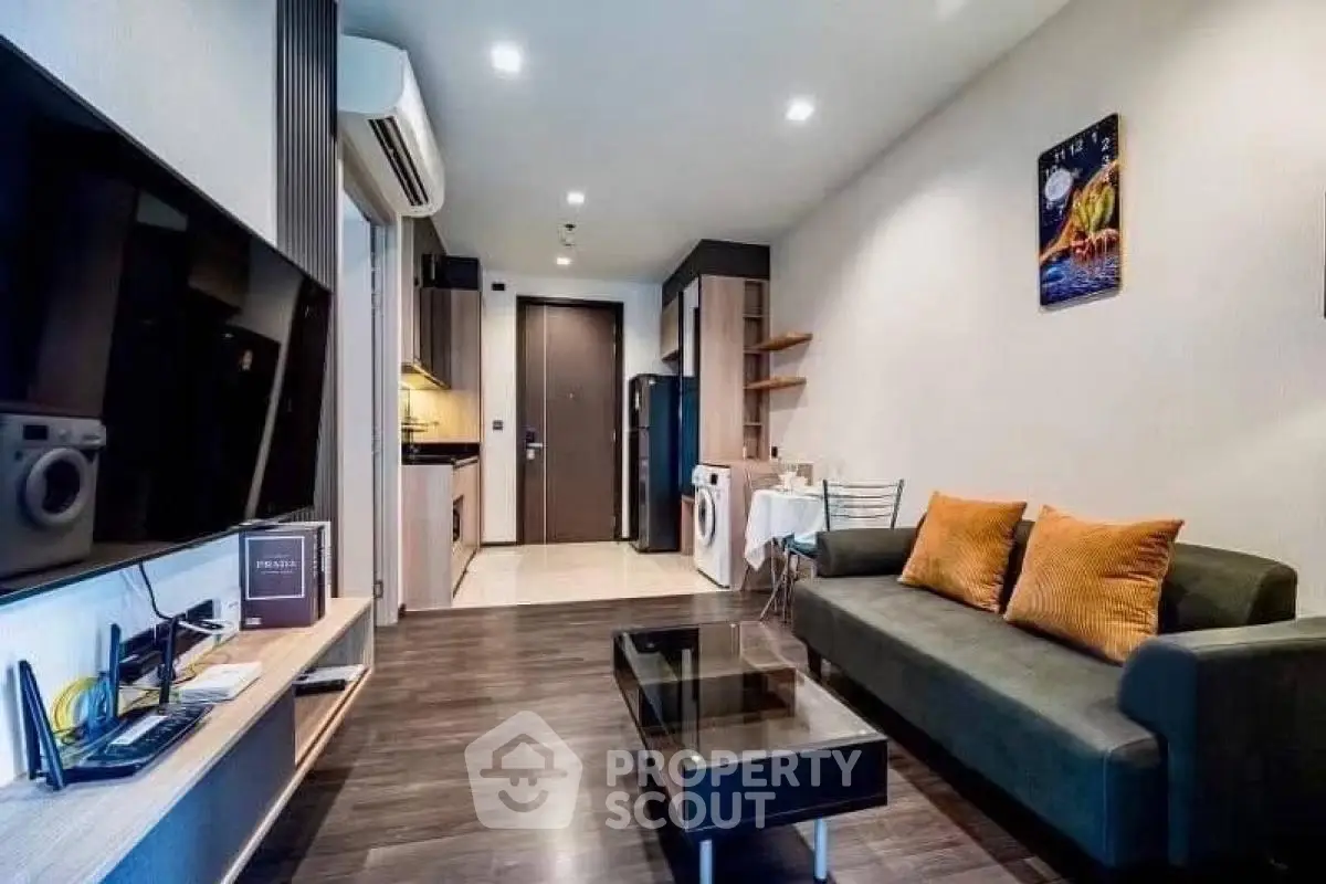 Modern living room with sleek design and open kitchen layout