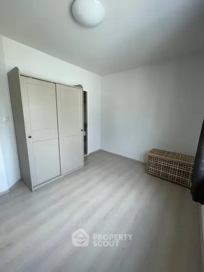 Spacious minimalist bedroom with sleek wardrobe and natural light