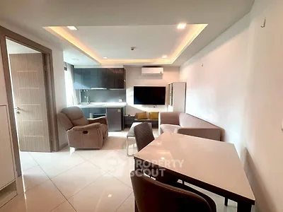 Modern living room with sleek furniture and open kitchen layout