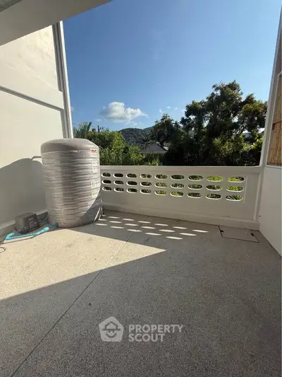 Spacious balcony with scenic view and modern design, perfect for relaxation.