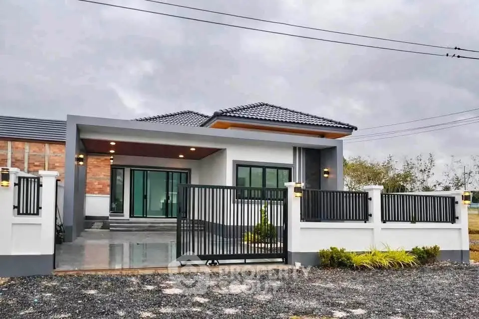 Modern single-story house with sleek design and spacious driveway, perfect for contemporary living.