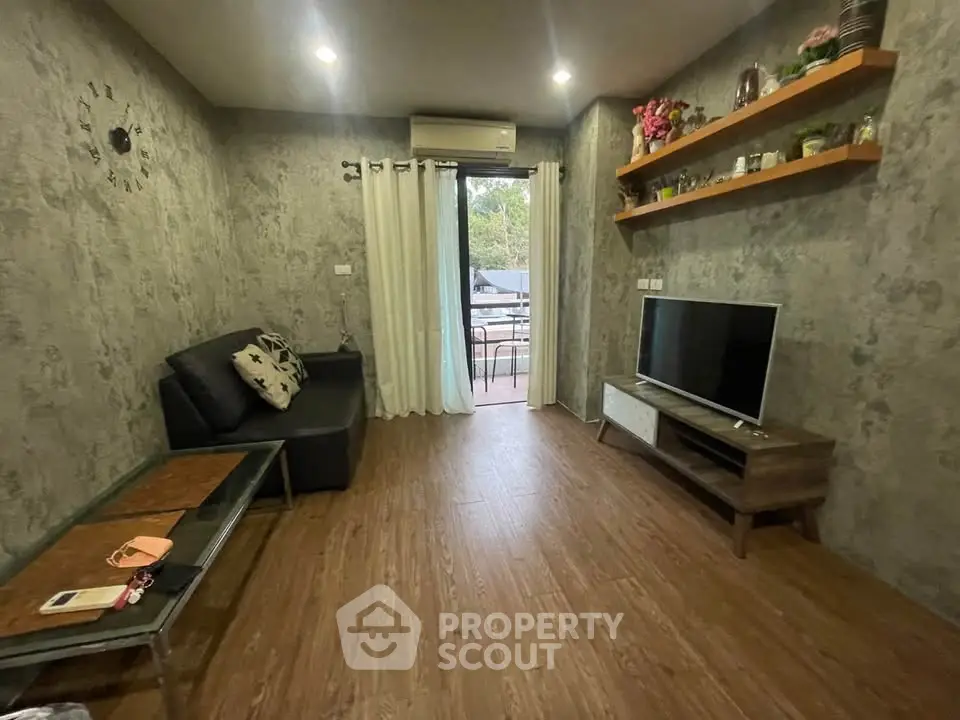 Cozy living room with modern decor and balcony access