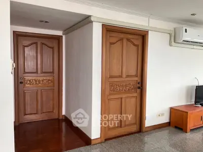 Spacious interior with wooden doors and air conditioning, ideal for comfortable living.