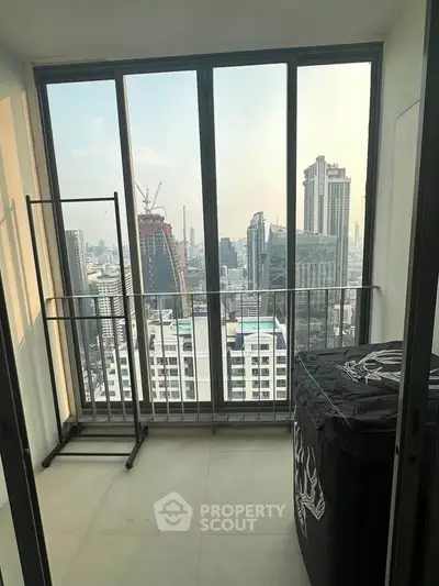 High-rise apartment with stunning city view and large windows, perfect for urban living.