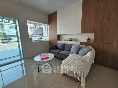 Modern living room with cozy sofa and stylish decor in a bright, open space.