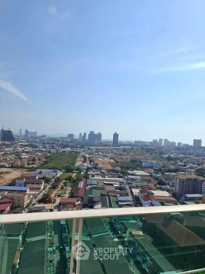 Stunning cityscape view from a high-rise balcony showcasing urban skyline and distant horizon.