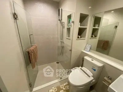 Modern bathroom with glass shower enclosure and sleek fixtures