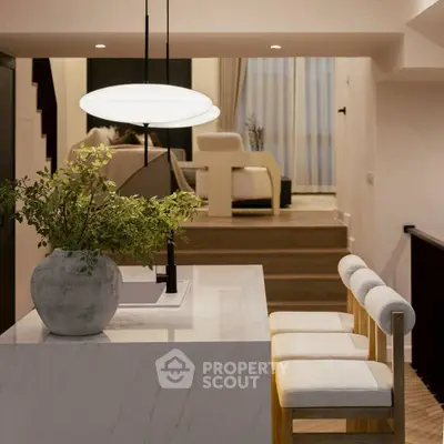 Modern open-plan living room with stylish furniture and elegant lighting