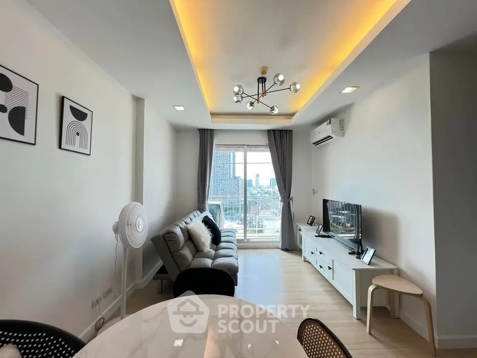 Modern living room with stylish decor and city view, featuring a cozy sofa and elegant lighting.