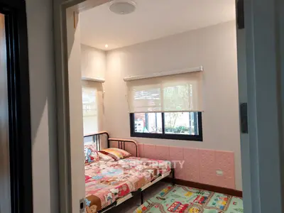Charming children's bedroom with playful decor and natural light.