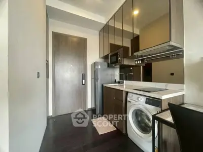 Modern compact kitchen with washing machine and sleek cabinetry