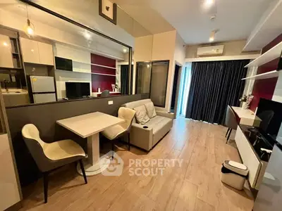 Modern living room with stylish furniture and open kitchen layout in a cozy apartment.