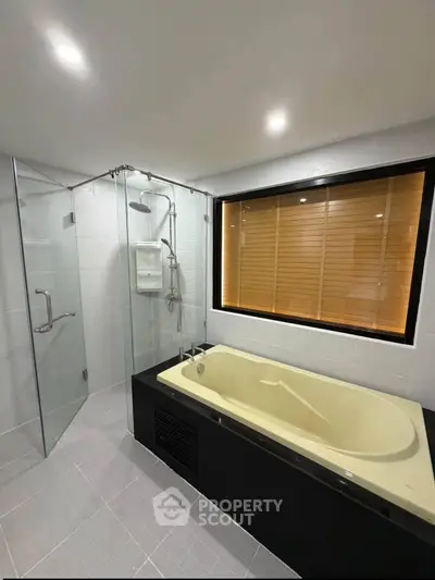 Luxurious bathroom with modern bathtub and glass shower enclosure