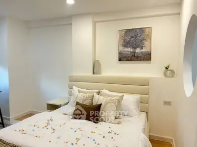 Cozy bedroom with modern decor and soft lighting, perfect for relaxation.