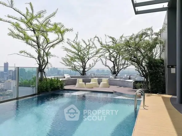 Luxurious rooftop pool with stunning city view and modern seating area.