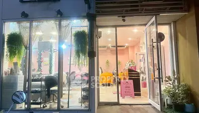 Charming commercial space with large windows and modern interior design, ideal for a beauty salon or boutique.