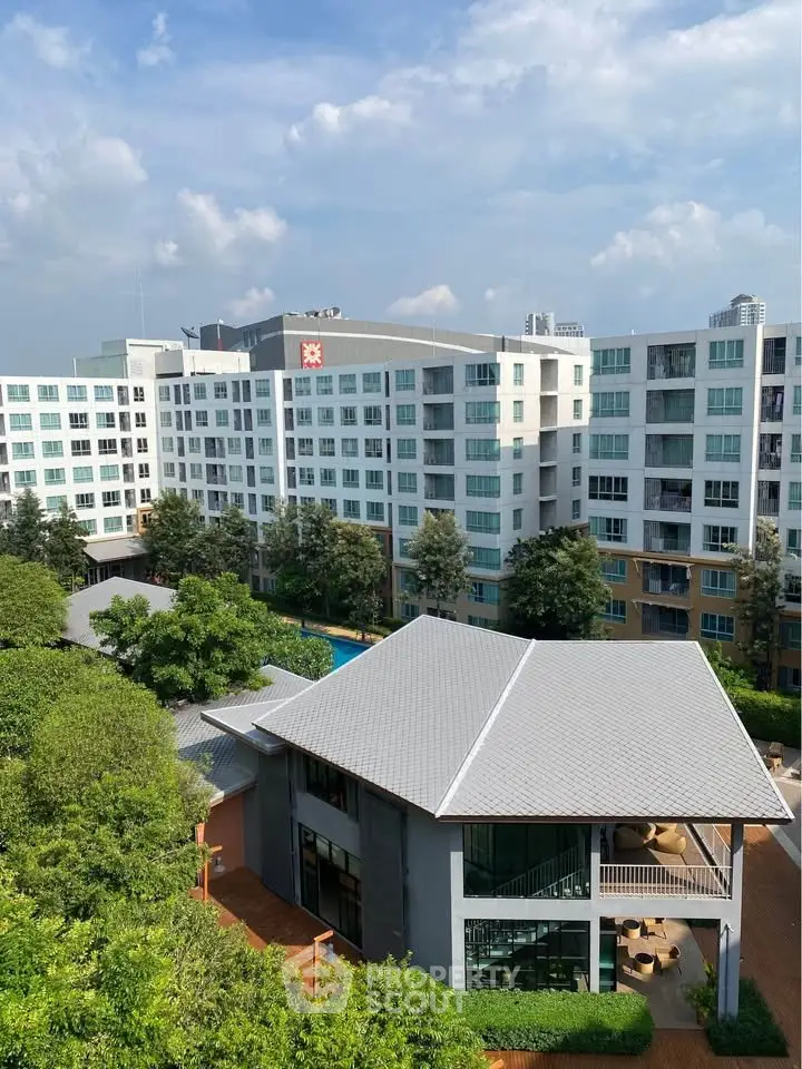 Modern residential complex with lush greenery and spacious balconies