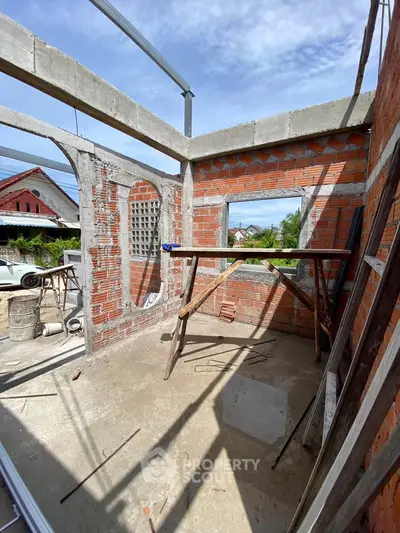 Under-construction building showcasing brick walls and open framework, ideal for customization.