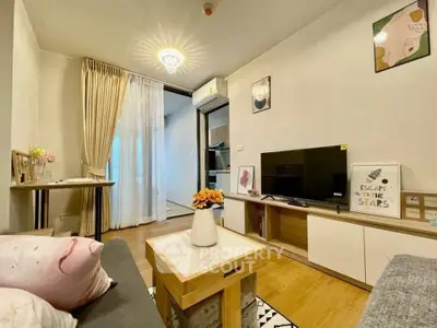 Charming living room with modern decor and cozy ambiance, featuring stylish furniture and elegant lighting.