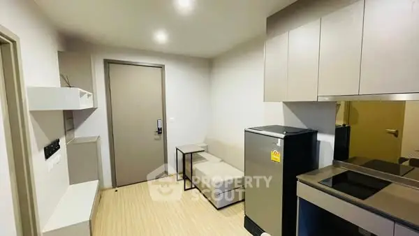 Modern compact living room with kitchenette and sleek design