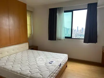 Spacious bedroom with city view, featuring a large window and wooden flooring, perfect for urban living.