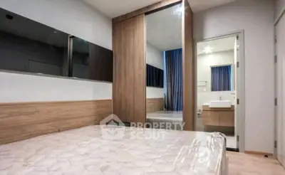 Modern bedroom with ensuite bathroom and stylish wooden accents
