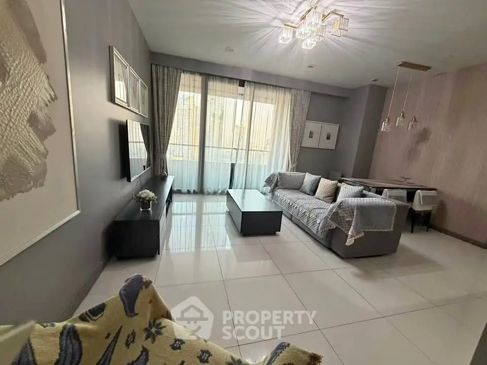 Spacious modern living room with elegant decor and large windows for natural light.