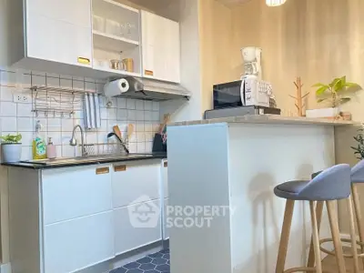 Charming modern kitchen with breakfast bar and stylish stools, perfect for cozy meals and gatherings.