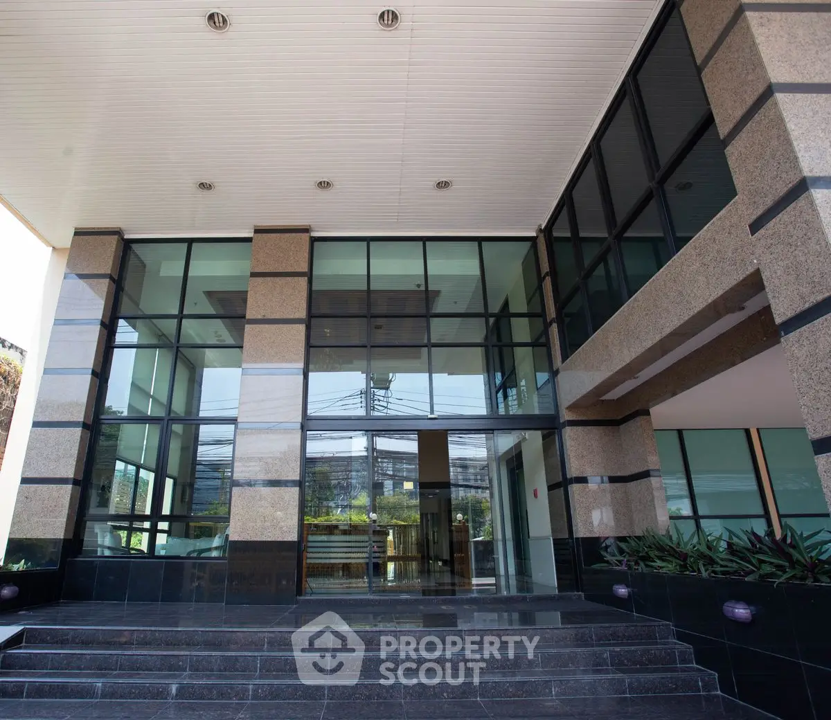 Modern building entrance with glass facade and sleek design