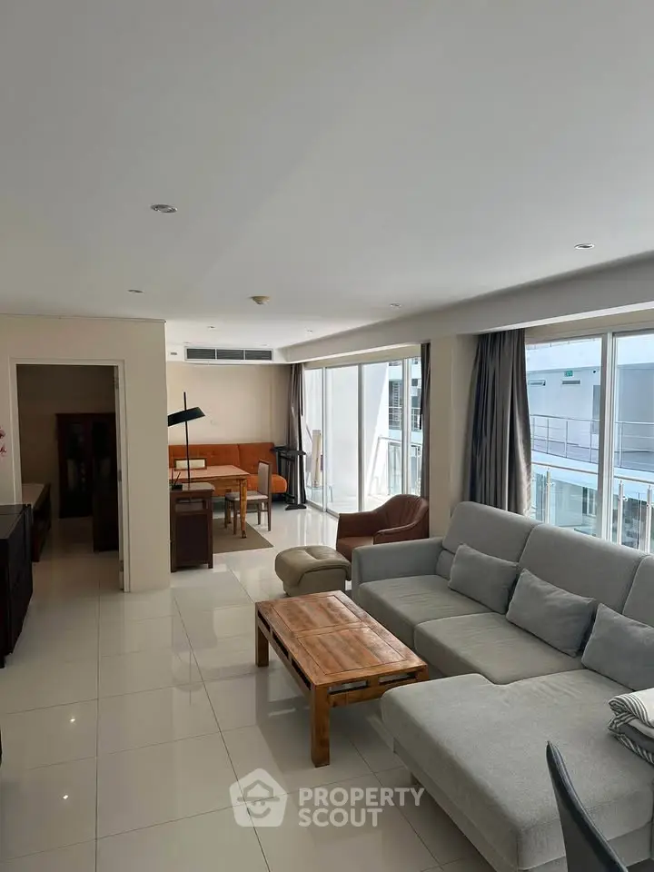 Spacious modern living room with large windows and stylish furniture