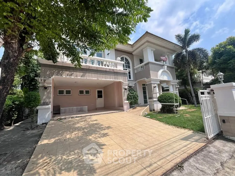 Elegant two-story house with spacious driveway and lush greenery