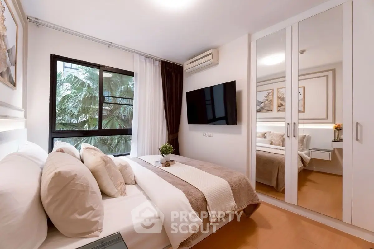 Modern bedroom with mirrored wardrobe and cozy decor