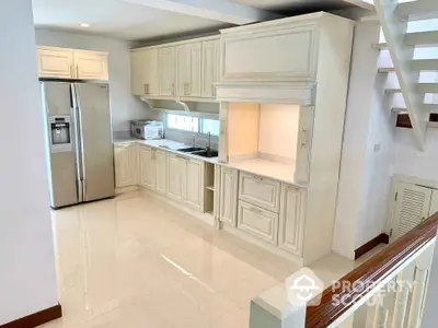 Spacious kitchen with modern appliances and elegant cabinetry in a bright, open layout.