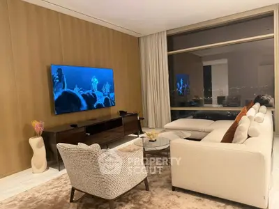 Luxurious living room with modern decor, large TV, and stunning city view through floor-to-ceiling windows.