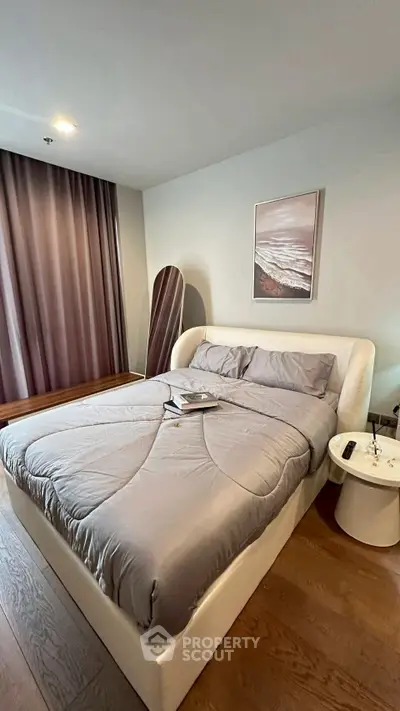 Modern bedroom with stylish decor and cozy bedding in a contemporary apartment.