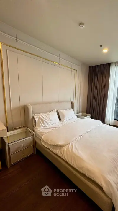 Luxurious bedroom with elegant decor and plush bedding in a modern apartment.