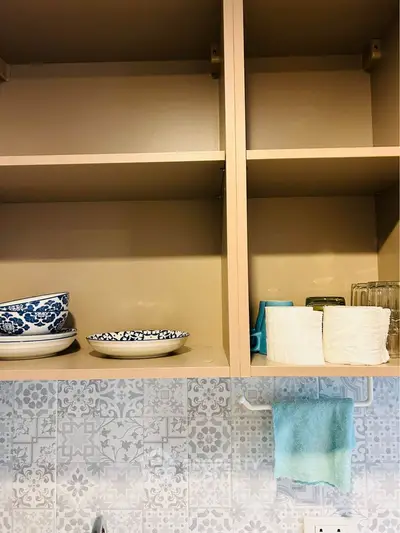 Charming kitchen with open shelving and decorative tiles, perfect for modern living.