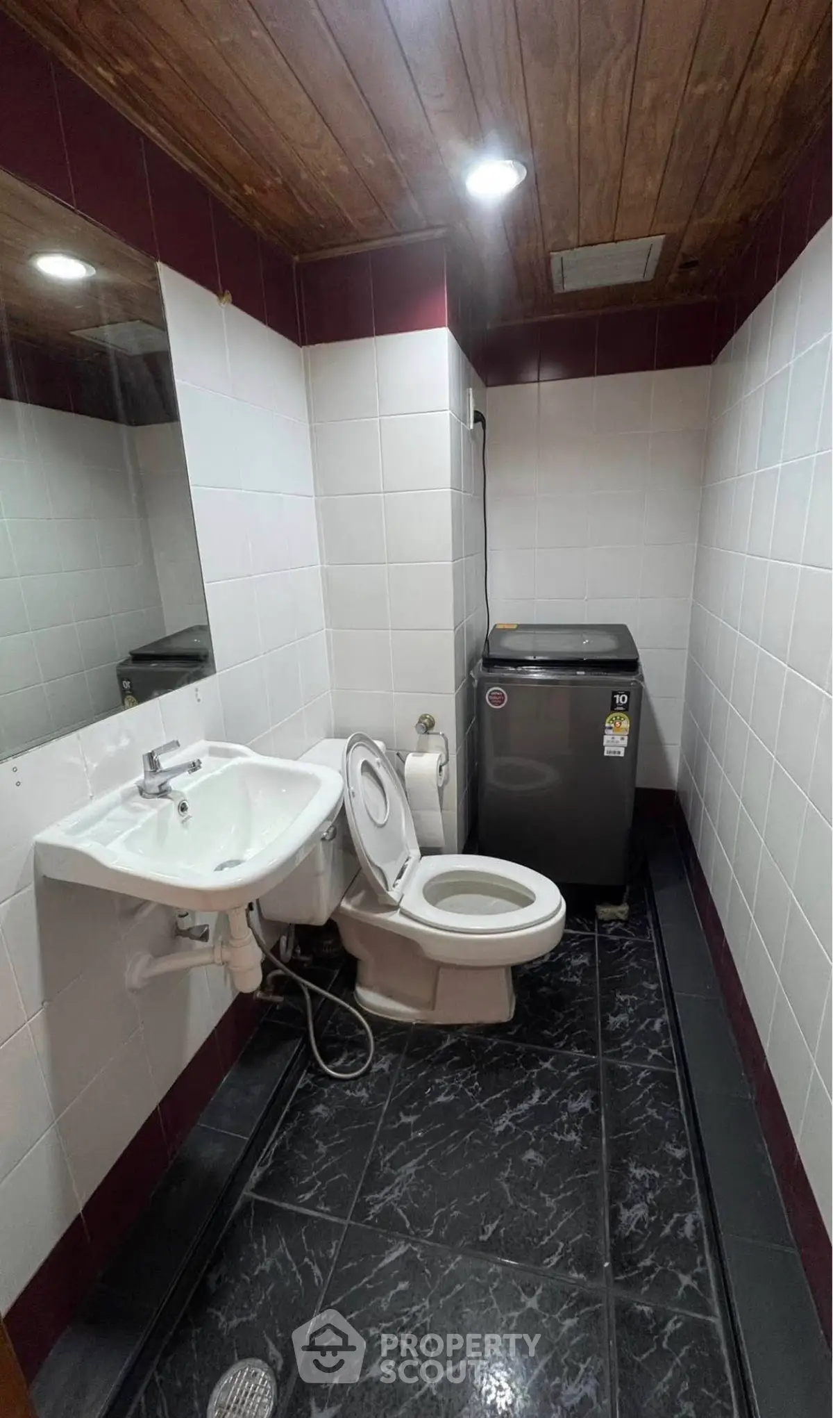 Compact bathroom with washing machine and modern fixtures