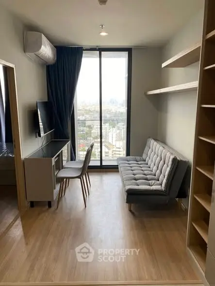Modern living room with city view, featuring sleek furniture and natural light.