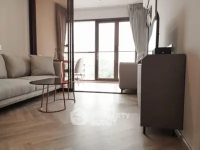 Modern living room with stylish furniture and large windows offering natural light.