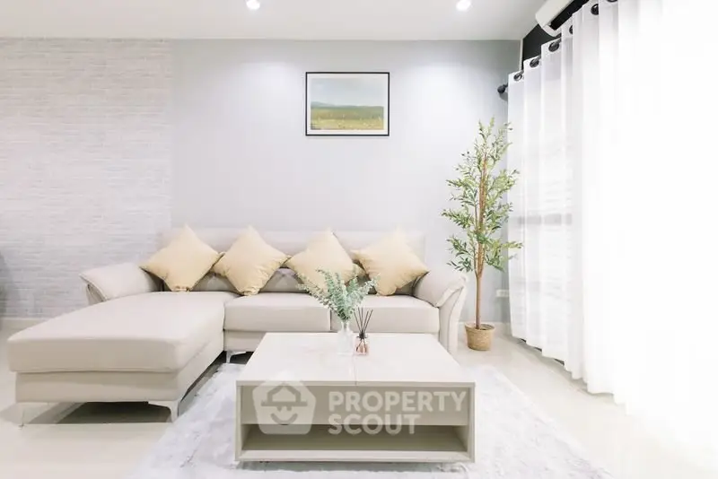 Modern living room with beige sectional sofa and elegant decor