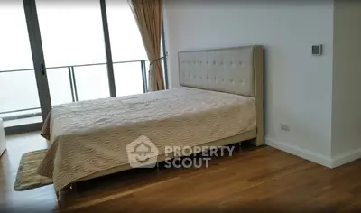 Spacious bedroom with elegant decor and balcony access