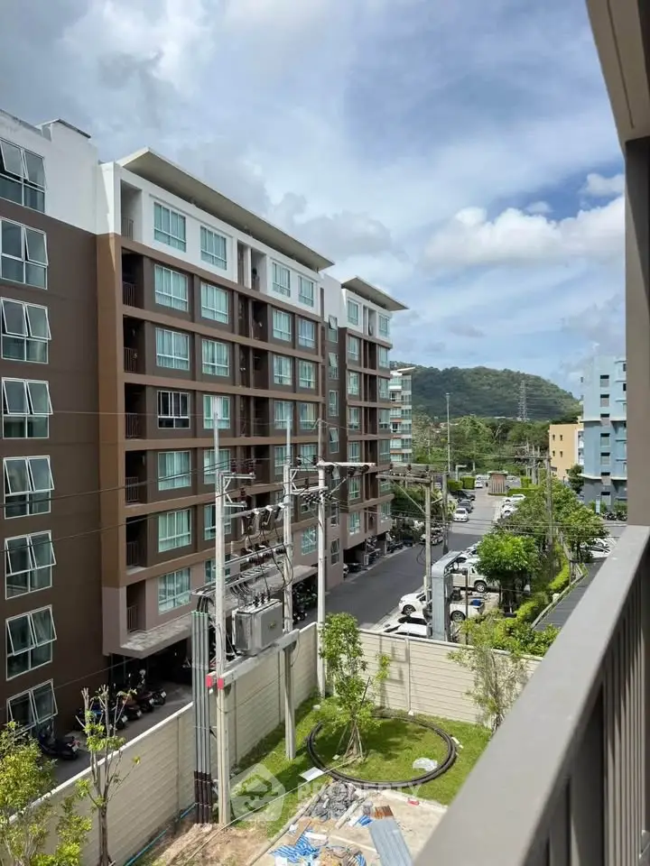 Modern apartment building with scenic mountain view from balcony